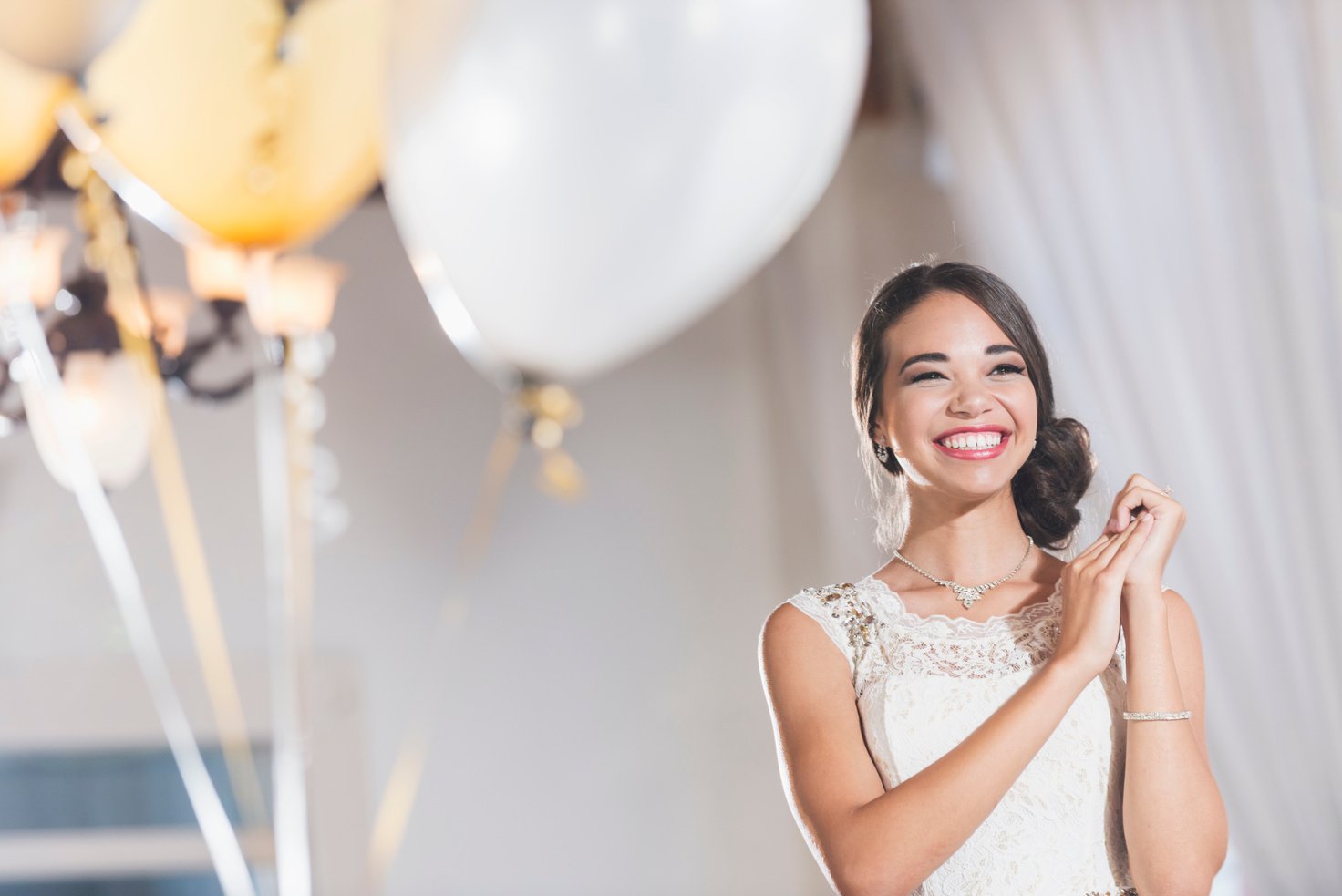 Young mixed race woman in white dress at party